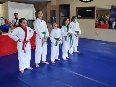 a group of people in karate uniforms