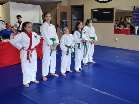 a group of people in karate uniforms