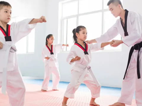 a group of people in karate uniforms