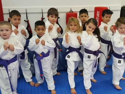 a group of kids in karate uniforms