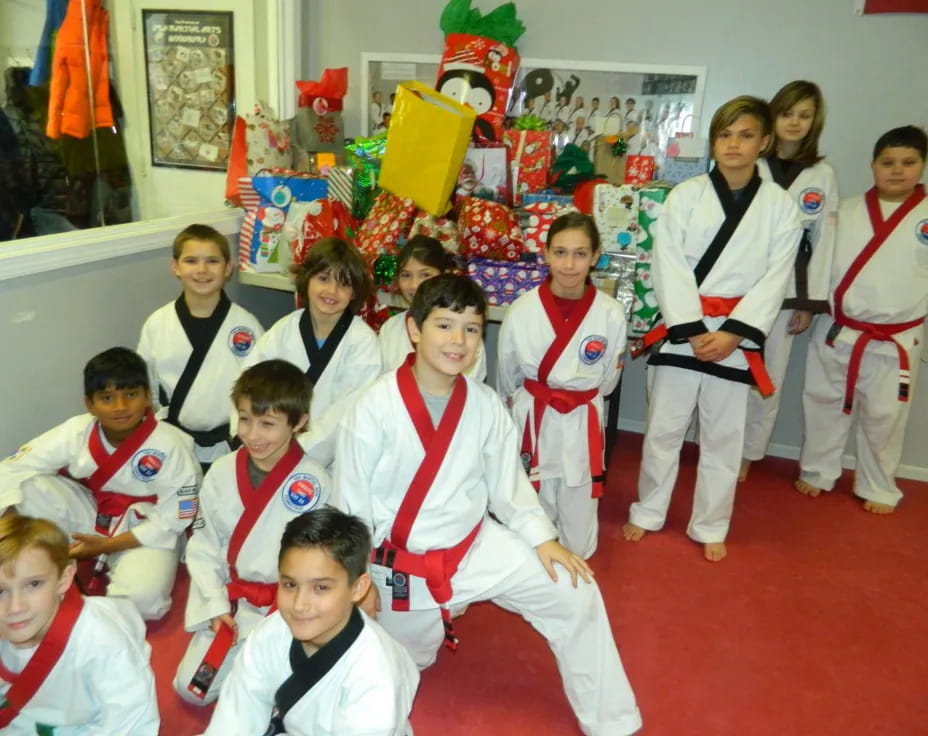 a group of children in karate uniforms