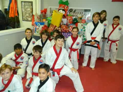 a group of children in karate uniforms