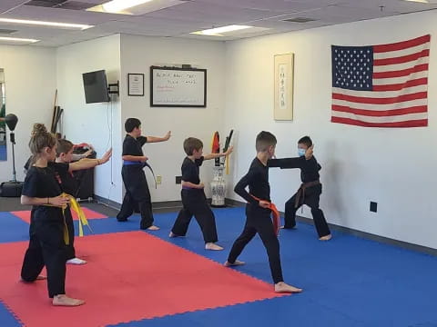 a group of kids practicing martial arts