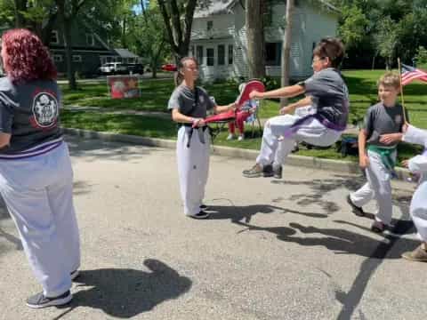 a group of people playing with a toy sword