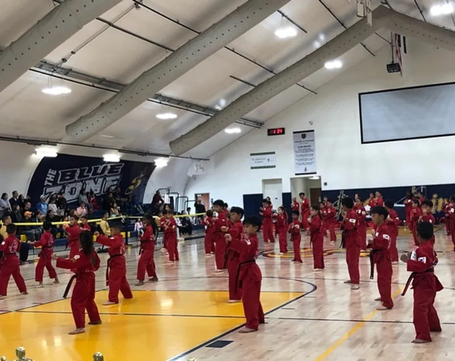 a group of people in red uniforms in a gym