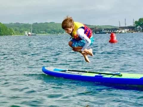 a boy jumping off a surfboard