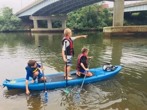 a group of kids in a canoe