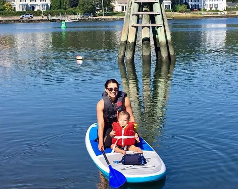 a person and a child on a small boat in a body of water