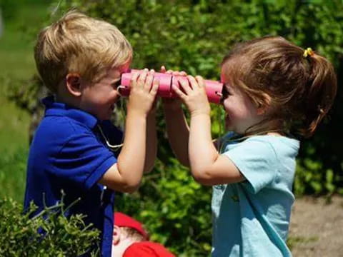 a couple of children playing with a toy gun