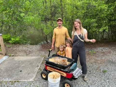 a man and woman with children and a grill with a group of people