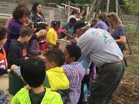 a group of people gathered around a person in a green shirt