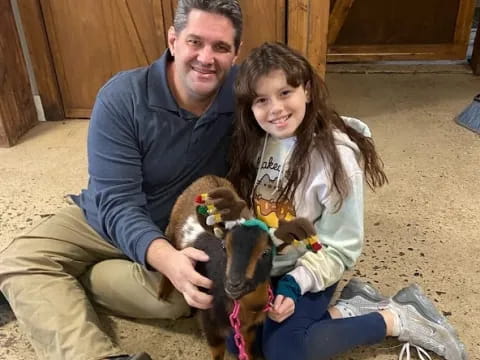 a person and a girl holding a dog