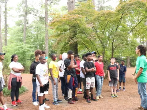 a group of people standing in a line in a forest