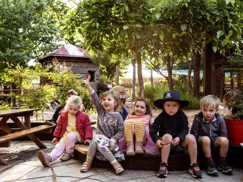 a group of children sitting on a bench