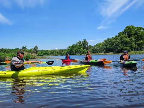 a group of people in kayaks on a lake