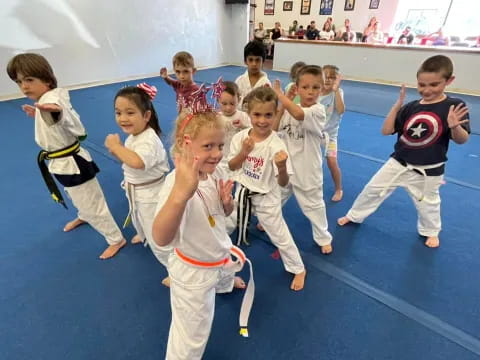 a group of children in karate uniforms