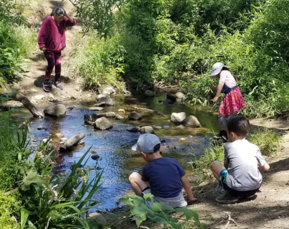 a group of people by a river