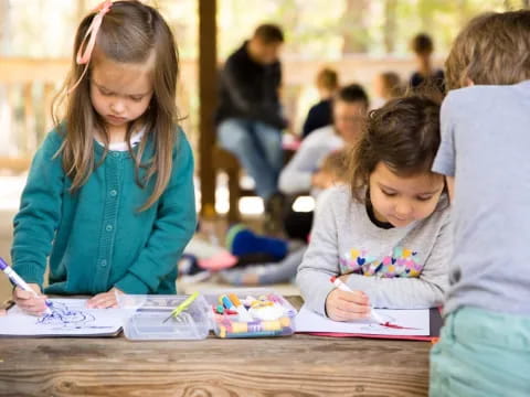 a group of children writing on paper