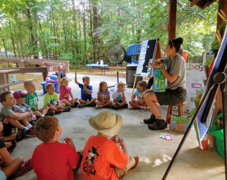 a person teaching children in a play area