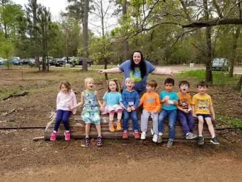 a person and a group of children posing for a photo