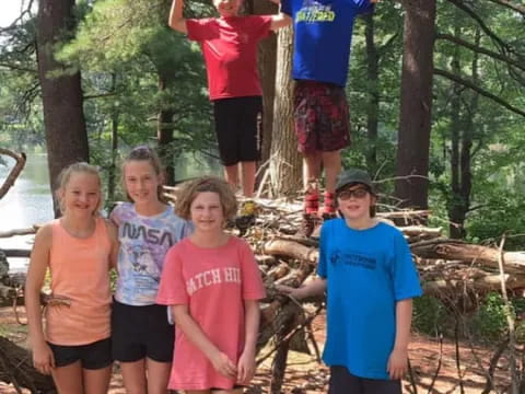 a group of people posing for a photo in the woods