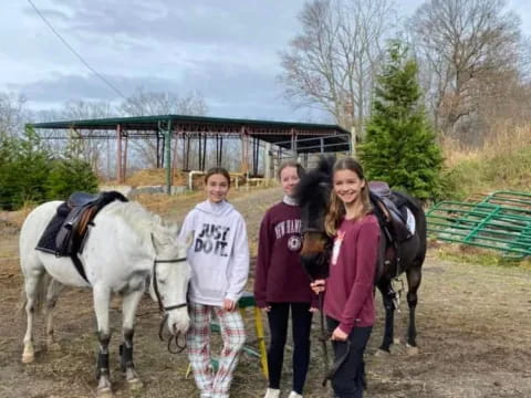 a group of people standing next to a horse