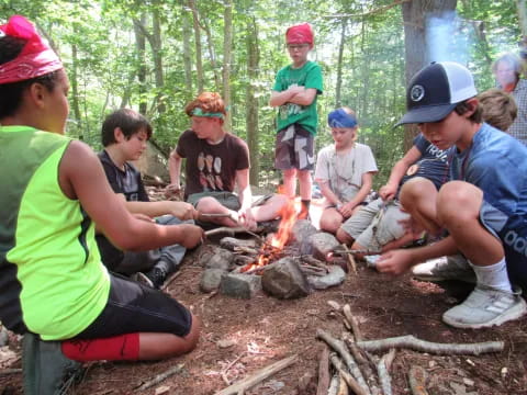 a group of people around a campfire