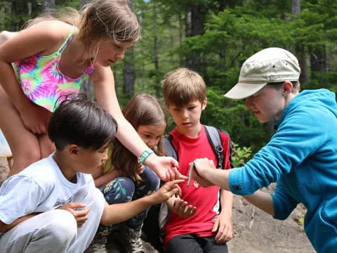 a group of people gathered around a person and a child