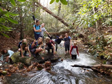 a group of people standing in a stream