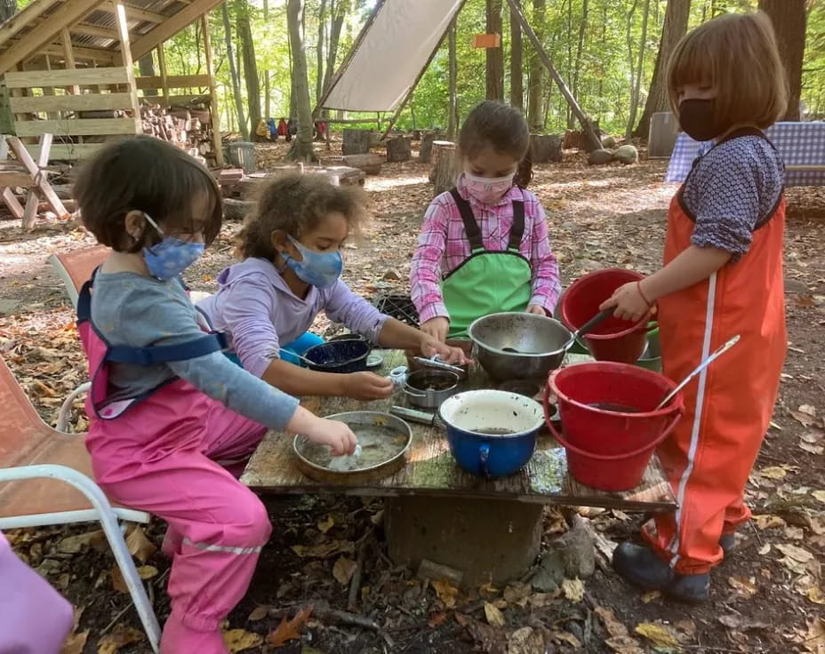 a group of children cooking outside