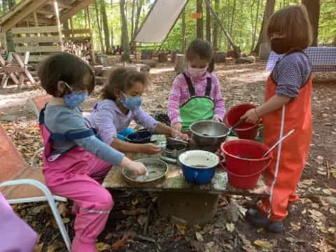 a group of children cooking outside