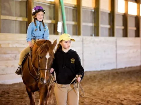 a person and a girl riding horses