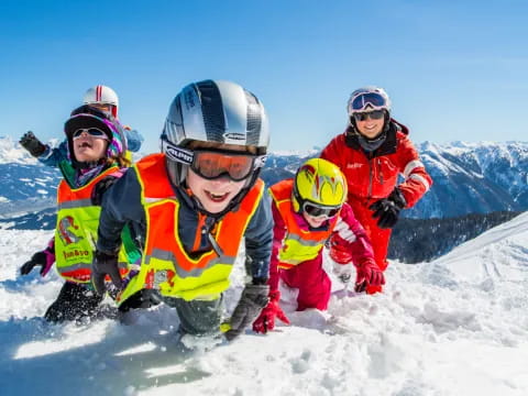 a group of people wearing helmets and standing on a snowy mountain