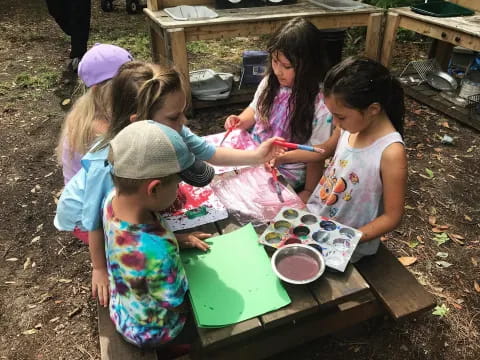 a group of children painting