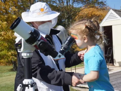 a child looking through a microscope