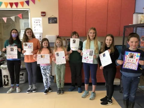 a group of people holding certificates