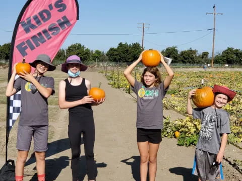 a group of kids holding pumpkins