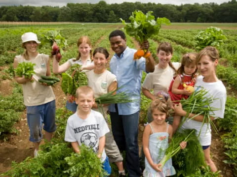 a group of people posing for a photo in a farm