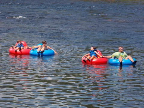 a group of people on inner tubes in the water