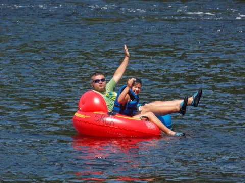 a man and a woman on a floating device in the water