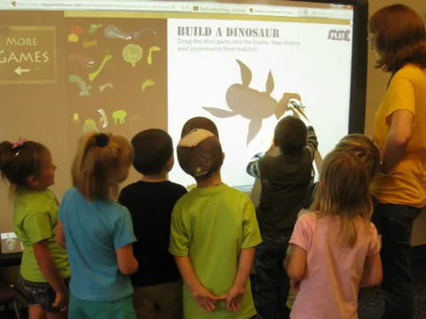 a group of children looking at a projected image