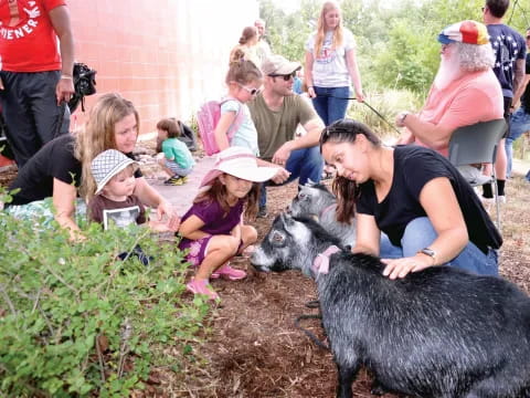 a group of people petting dogs