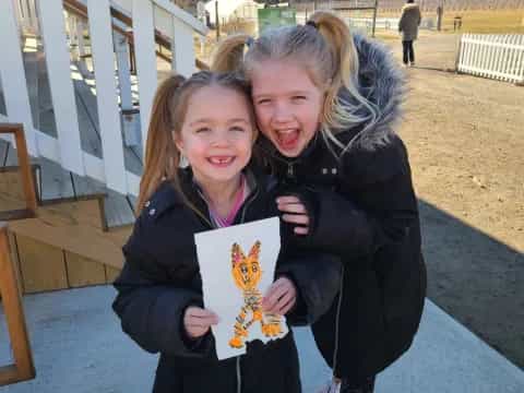a couple of girls holding a picture