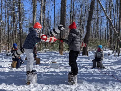 a group of people stand around a snowboard