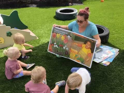 a person and several children painting