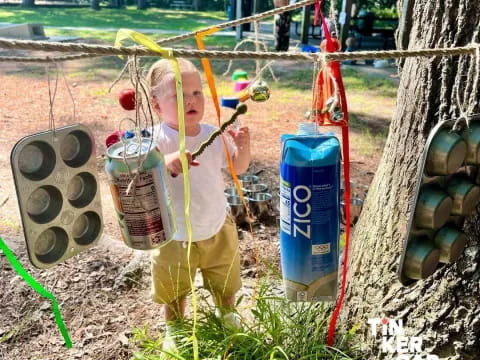 a boy holding a bottle of water