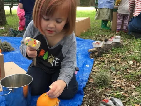 a child carving a pumpkin
