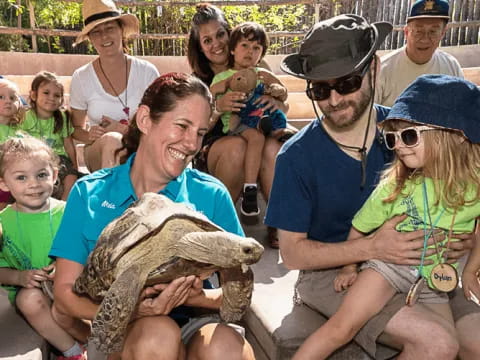 a group of people sitting on a bench with a baby