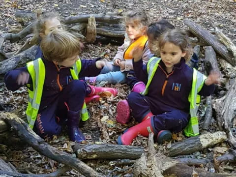 a group of children sitting on a log