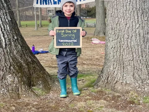 a child holding a sign
